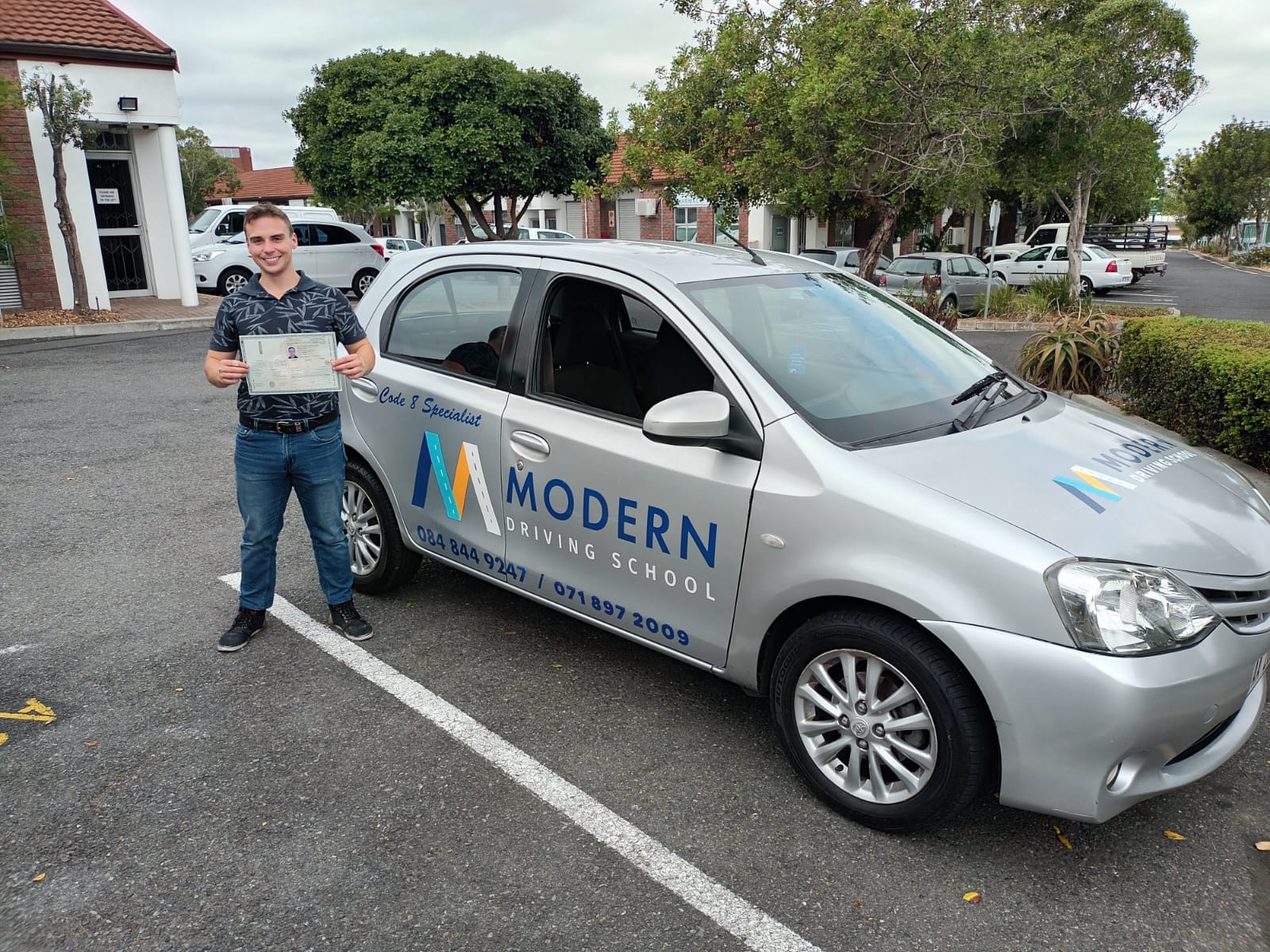 Learner in front of a Modern Driving School vehicle