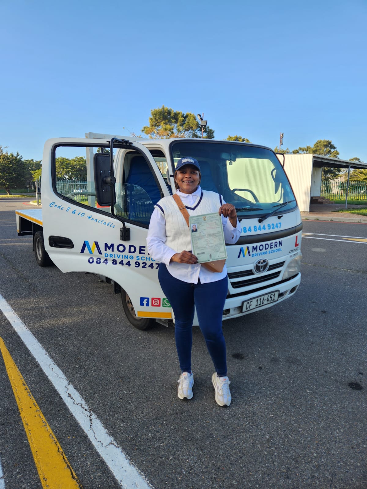 Modern Driving School learner with licence in hand