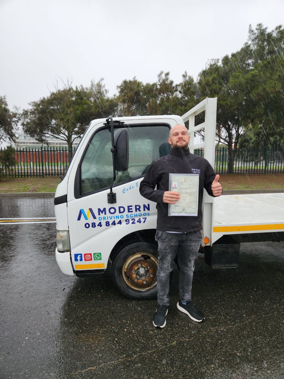 Student with certificate next to a Code 10 truck